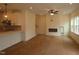 Open-concept living room with fireplace, ceiling fan, and large windows for ample natural light at 6973 Doddridge Ln # 17, Cary, NC 27519