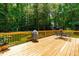 Spacious wooden deck with a grill, table, and chairs, perfect for outdoor entertaining at 7021 Oviedo Dr, Raleigh, NC 27603