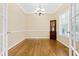 Elegant dining room featuring hardwood floors, classic chandelier, and detailed trim work at 7021 Oviedo Dr, Raleigh, NC 27603