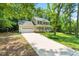 Charming two-story home with a well-manicured lawn, inviting front porch, and a long driveway at 7021 Oviedo Dr, Raleigh, NC 27603