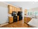 Bright kitchen with wood cabinets, black appliances, and hardwood floors at 7021 Oviedo Dr, Raleigh, NC 27603