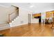 Open floor plan with hardwood floors and view of kitchen and staircase at 7021 Oviedo Dr, Raleigh, NC 27603