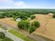 Expansive aerial view of property with fields, pond, mature trees, and road access at 7042 Us 401 Highway N, Fuquay Varina, NC 27526