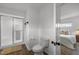 A clean, white bathroom with glass shower and tile, connecting to a bedroom for convenience at 7042 Us 401 Highway N, Fuquay Varina, NC 27526