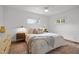 Comfortable bedroom with a ceiling fan, hardwood floors, and a cozy bed dressed with decorative pillows and a throw blanket at 7042 Us 401 Highway N, Fuquay Varina, NC 27526