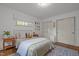 Cozy bedroom with hardwood floors, two closets, and a comfortable bed accented by decorative pillows and a patterned rug at 7042 Us 401 Highway N, Fuquay Varina, NC 27526