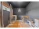 Dark gray Bedroom featuring two white cribs, hardwood floors, a decorative cowhide rug, and play kitchen at 7042 Us 401 Highway N, Fuquay Varina, NC 27526
