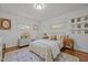 Bright bedroom featuring wood plank ceilings, hardwood floors, windows with roman shades, and lovely furnishings at 7042 Us 401 Highway N, Fuquay Varina, NC 27526