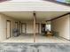 Attached carport providing convenient parking with lawn equipment and a grill for outdoor cooking at 7042 Us 401 Highway N, Fuquay Varina, NC 27526