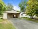 Attached carport providing convenient parking with lawn equipment and a grill for outdoor cooking at 7042 Us 401 Highway N, Fuquay Varina, NC 27526