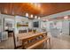Open dining room with a wooden ceiling, brick fireplace, and seamless flow to the kitchen at 7042 Us 401 Highway N, Fuquay Varina, NC 27526