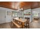 Charming dining room with a wooden ceiling, brick fireplace, and a large table at 7042 Us 401 Highway N, Fuquay Varina, NC 27526