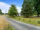 Tree lined driveway leads to updated ranch style house with mature yard at 7042 Us 401 Highway N, Fuquay Varina, NC 27526