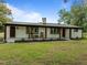 Charming home featuring painted brick, wood columns, rocking chairs and professionally landscaped yard at 7042 Us 401 Highway N, Fuquay Varina, NC 27526