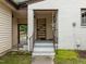 Charming front porch with white brick steps, a decorative shelf, and inviting entryway at 7042 Us 401 Highway N, Fuquay Varina, NC 27526