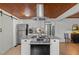 Open kitchen with granite counters, white cabinets, stainless steel appliances, and a wood ceiling at 7042 Us 401 Highway N, Fuquay Varina, NC 27526