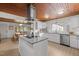 Spacious kitchen with a center island, stainless steel appliances, and a dining area in the background at 7042 Us 401 Highway N, Fuquay Varina, NC 27526