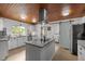 Modern kitchen with an island, granite counters, white cabinets, and stainless steel appliances at 7042 Us 401 Highway N, Fuquay Varina, NC 27526