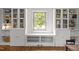 Bright living room features a window seat nook between built in bookcases and hardwood floors at 7042 Us 401 Highway N, Fuquay Varina, NC 27526