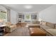 Bright living room featuring large windows, built-in bookcases, and comfortable, neutral-toned furniture at 7042 Us 401 Highway N, Fuquay Varina, NC 27526