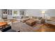 Open living room with a large sectional sofa, leather ottoman, and built-in bookshelves at 7042 Us 401 Highway N, Fuquay Varina, NC 27526