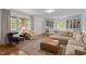 Spacious living room with hardwood floors, ample windows, built-in shelving, and comfortable seating at 7042 Us 401 Highway N, Fuquay Varina, NC 27526