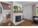 Cozy living room features a white brick fireplace and hardwood floors at 7042 Us 401 Highway N, Fuquay Varina, NC 27526