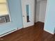 This bedroom has light blue walls and wood flooring at 709 Gerard St, Durham, NC 27701