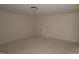 Unfinished basement features neutral walls, ceiling light, and a door at 7102 Hubner Pl # 46, Cary, NC 27519