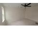 A cozy bedroom featuring a ceiling fan and a well-lit space from the window at 7102 Hubner Pl # 46, Cary, NC 27519