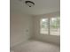 Bedroom with two windows providing plenty of natural light and an installed ceiling light at 7102 Hubner Pl # 46, Cary, NC 27519