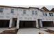 View of new construction townhomes featuring a garage and large windows at 7102 Hubner Pl # 46, Cary, NC 27519