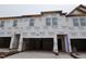 View of new construction townhomes featuring a garage and large windows at 7102 Hubner Pl # 46, Cary, NC 27519