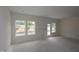 Living room with a view of the backyard through large windows and a glass door at 7102 Hubner Pl # 46, Cary, NC 27519