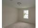 Well-lit bedroom featuring a window and ceiling light at 7104 Hubner Pl # 45, Cary, NC 27519