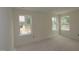 Bedroom with neutral walls and two large windows offering natural light and outdoor views at 7106 Hubner Pl # 44, Cary, NC 27519