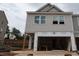 New two-story home exterior with light gray siding and a spacious two-car garage at 7106 Hubner Pl # 44, Cary, NC 27519