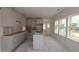 Bright kitchen featuring white cabinets, an island, and large windows for natural light at 7106 Hubner Pl # 44, Cary, NC 27519