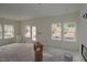 Spacious living room with neutral walls, large windows, and a door leading to outdoor space at 7106 Hubner Pl # 44, Cary, NC 27519