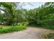 Driveway surrounded by green landscape and trees at 720 Sherrybrook Dr, Raleigh, NC 27610