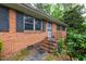 Close-up of a brick home's entrance with a decorative door and well-maintained landscaping at 720 Sherrybrook Dr, Raleigh, NC 27610