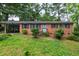 Charming brick ranch-style home featuring mature landscaping and a convenient carport at 720 Sherrybrook Dr, Raleigh, NC 27610