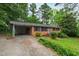 Inviting single-story brick home with a practical carport and a well-maintained front lawn at 720 Sherrybrook Dr, Raleigh, NC 27610