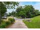 Street view of community with lush trees and green landscape in a quiet neighborhood at 720 Sherrybrook Dr, Raleigh, NC 27610