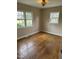 A bright bedroom that is freshly painted with hardwood floors and electrical outlets at 726 Thompson St, Pittsboro, NC 27312
