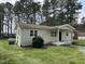 Single-story home showcasing a well-maintained lawn, clean siding, and efficient propane tank at 726 Thompson St, Pittsboro, NC 27312