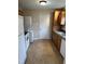 Functional kitchen featuring white appliances, wood cabinets, and durable flooring at 726 Thompson St, Pittsboro, NC 27312