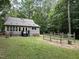 Spacious backyard with green grass and mature trees, complete with a garden at 8116 Reynard Rd, Chapel Hill, NC 27516