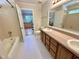 Bathroom features double sink vanity, tiled floor, and shower with tub at 8116 Reynard Rd, Chapel Hill, NC 27516