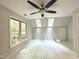 Airy bedroom with multiple windows, a ceiling fan, and walls painted a neutral shade at 8116 Reynard Rd, Chapel Hill, NC 27516